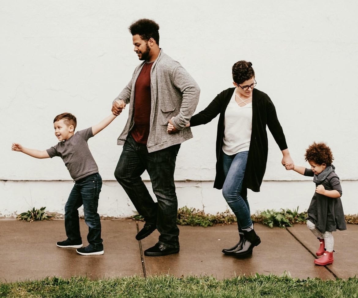 Screenshot of an instagram post of a family holding hands